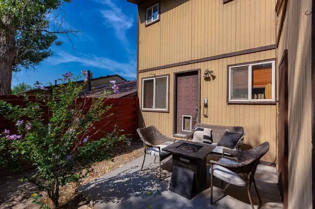 a backyard of a house with table and chairs