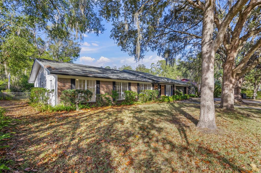 2110 Northwest 46th Street Gainesville, FL 32605 - Photo 27 of 31 a front view of a house with a garden