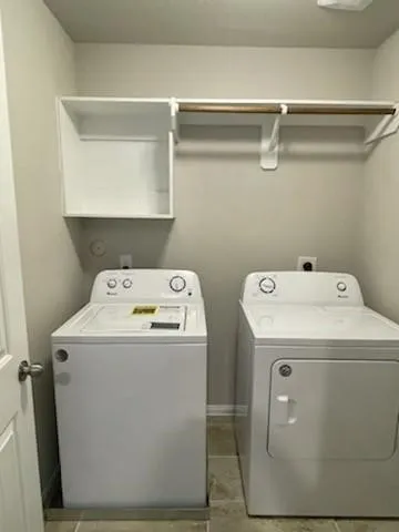 an empty room with windows and fan chandelier fan