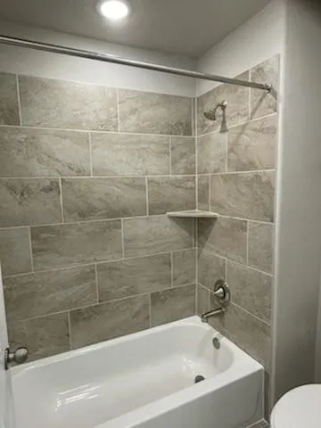 a view of an empty room with a chandelier fan