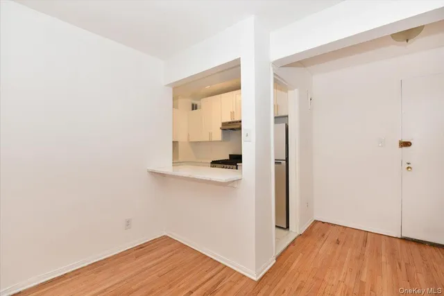 a view of a room with wooden floor and a bathroom