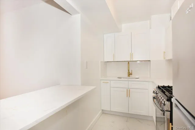 a view of a kitchen with white cabinets