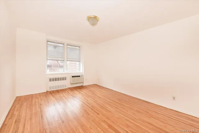 a view of an empty room and wooden floor