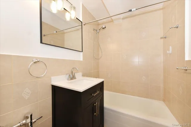 a bathroom with a sink mirror and a bathtub
