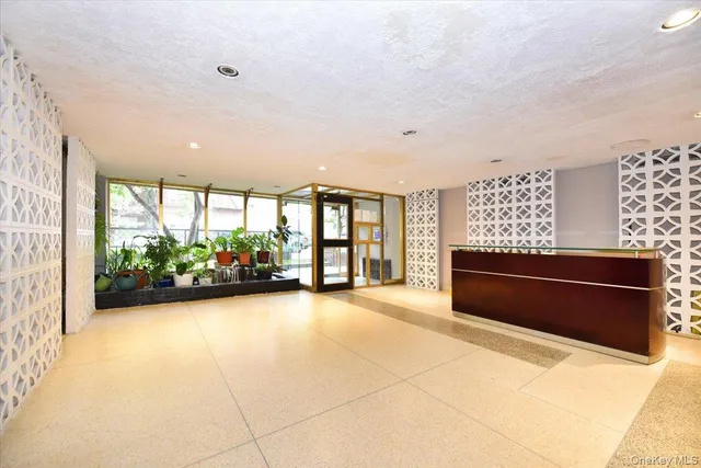 a view of room with furniture and large windows