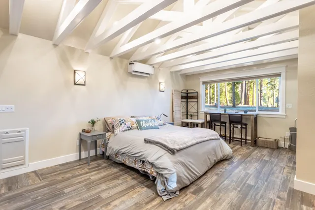 a view of a house with backyard and trees