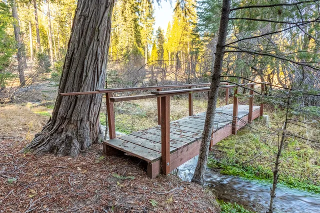 a view of a house with a yard and chairs