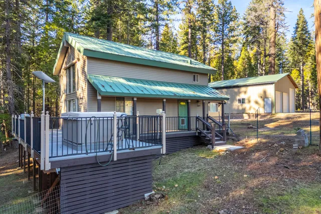 a kitchen with stainless steel appliances granite countertop a refrigerator a stove and a sink