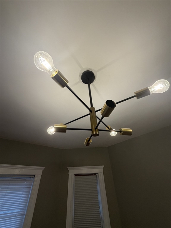 3943 Washington Street, Unit 1 Boston, MA 02131 - Photo 4 of 8 a view of a hallway with a chandelier fan