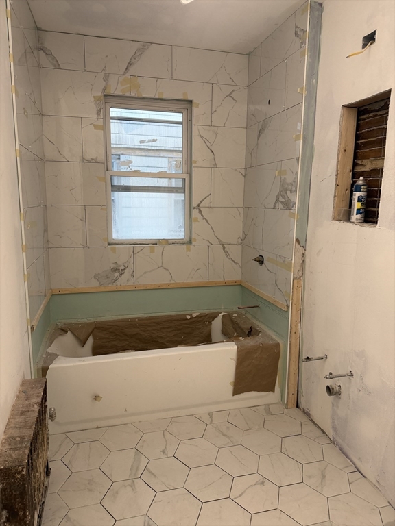 3943 Washington Street, Unit 1 Boston, MA 02131 - Photo 6 of 8 a bathroom with a bathtub and a shower