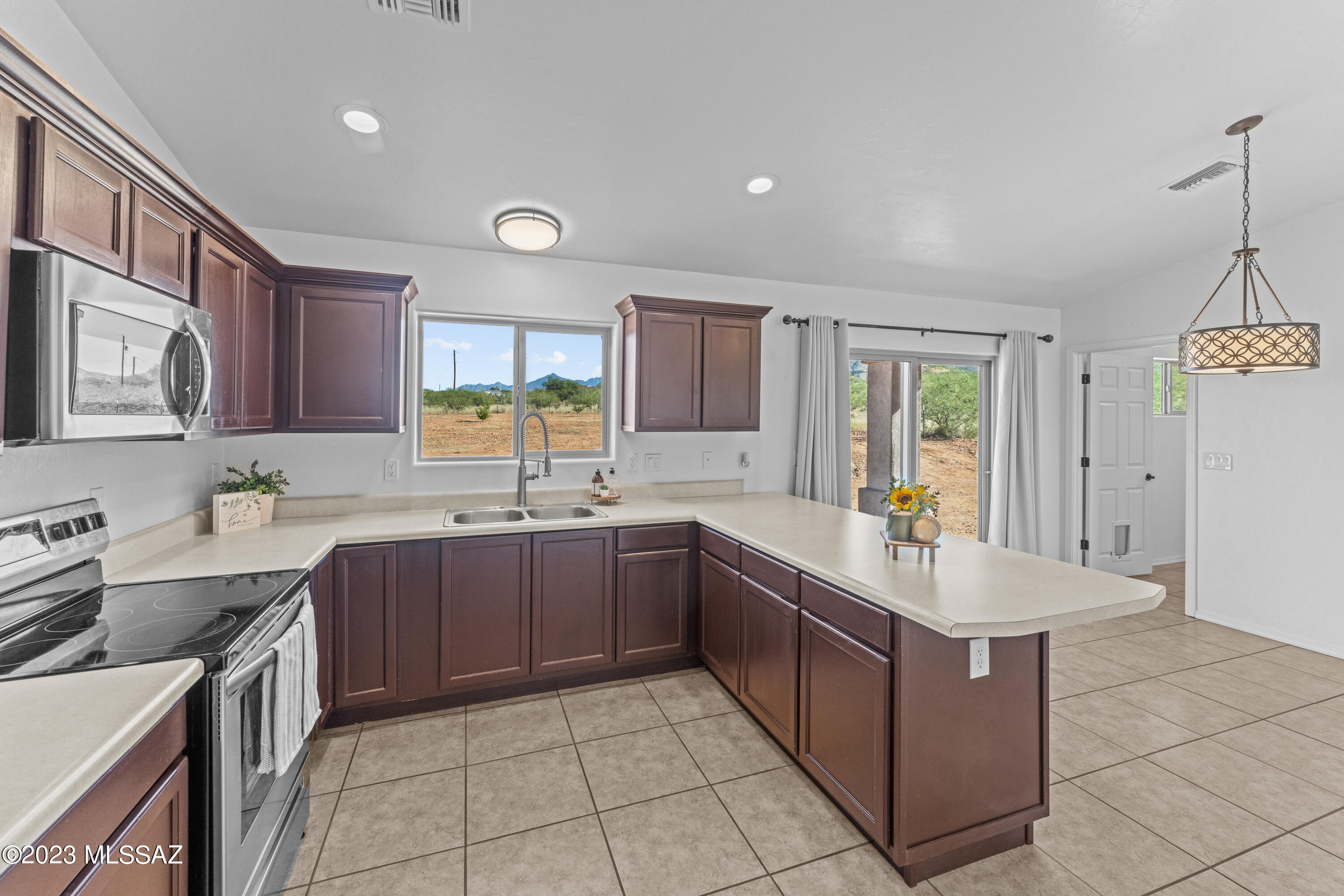 1615 Tonina Court Rio Rico, AZ 85648 - Photo 11 of 28 a large kitchen with lot of cabinets and sink