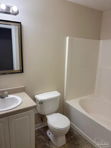 a white toilet sitting next to a bathroom sink