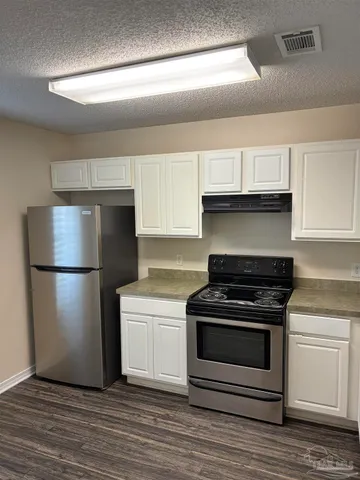 a kitchen with a stove and a refrigerator