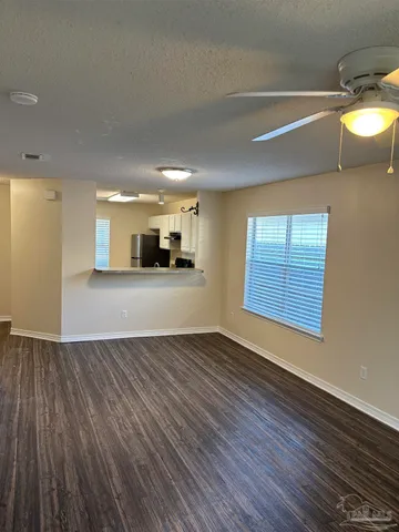 a view of a kitchen with a sink and dishwasher with wooden floor