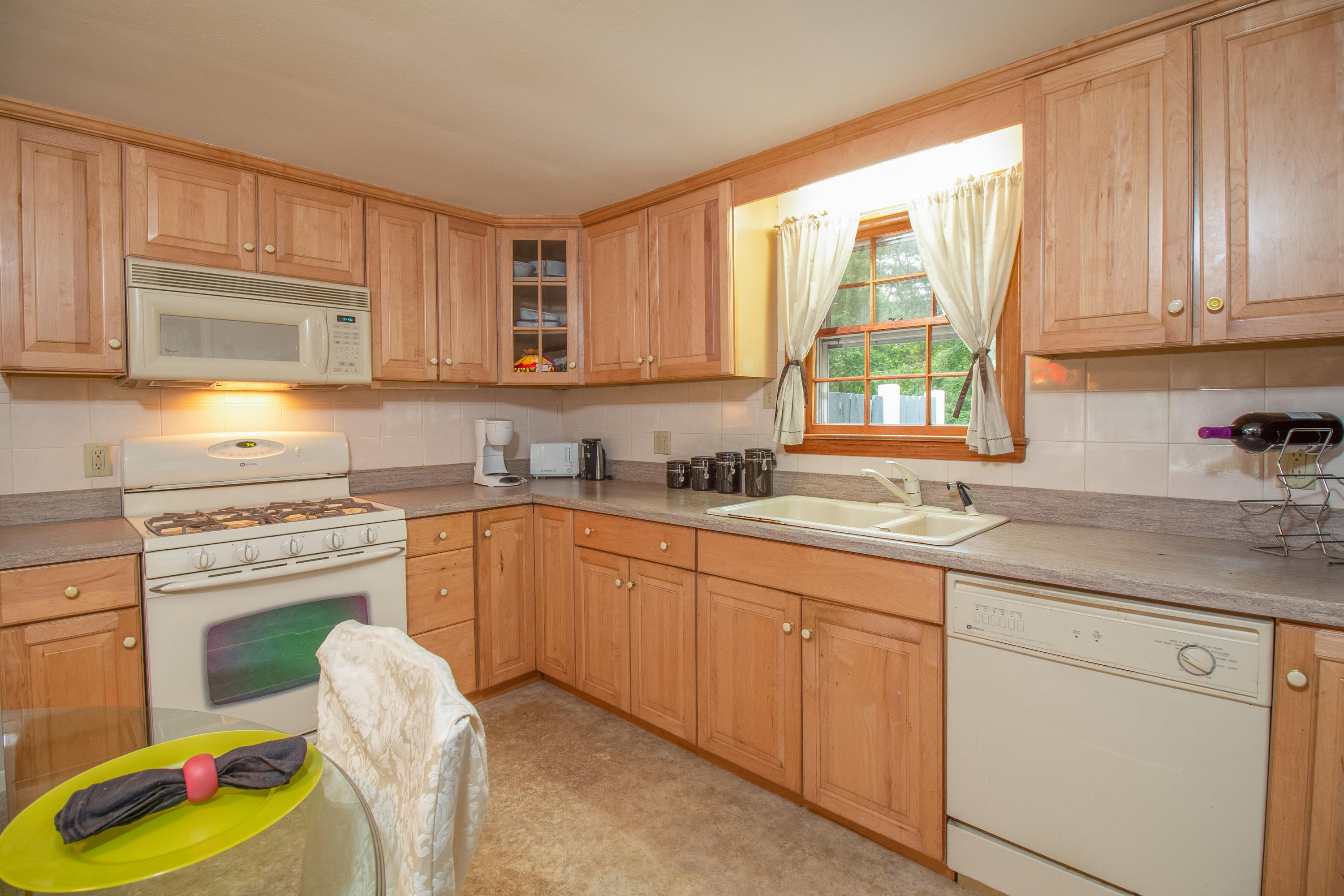 52 Farm Hill Road Centerville, MA 02632 - Photo 11 of 29 a kitchen with cabinets appliances and a window