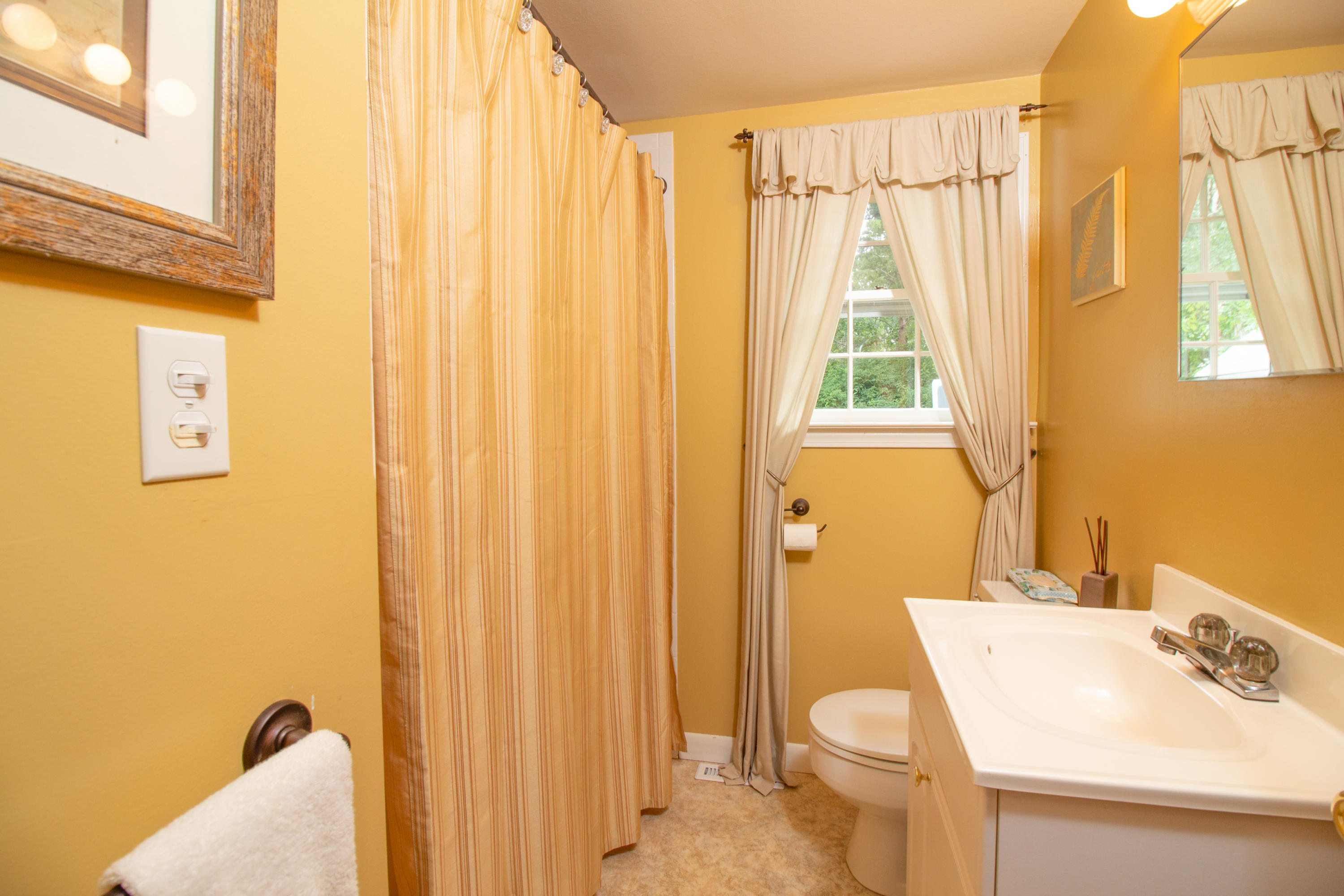 52 Farm Hill Road Centerville, MA 02632 - Photo 20 of 29 a bathroom with a sink a toilet and a window