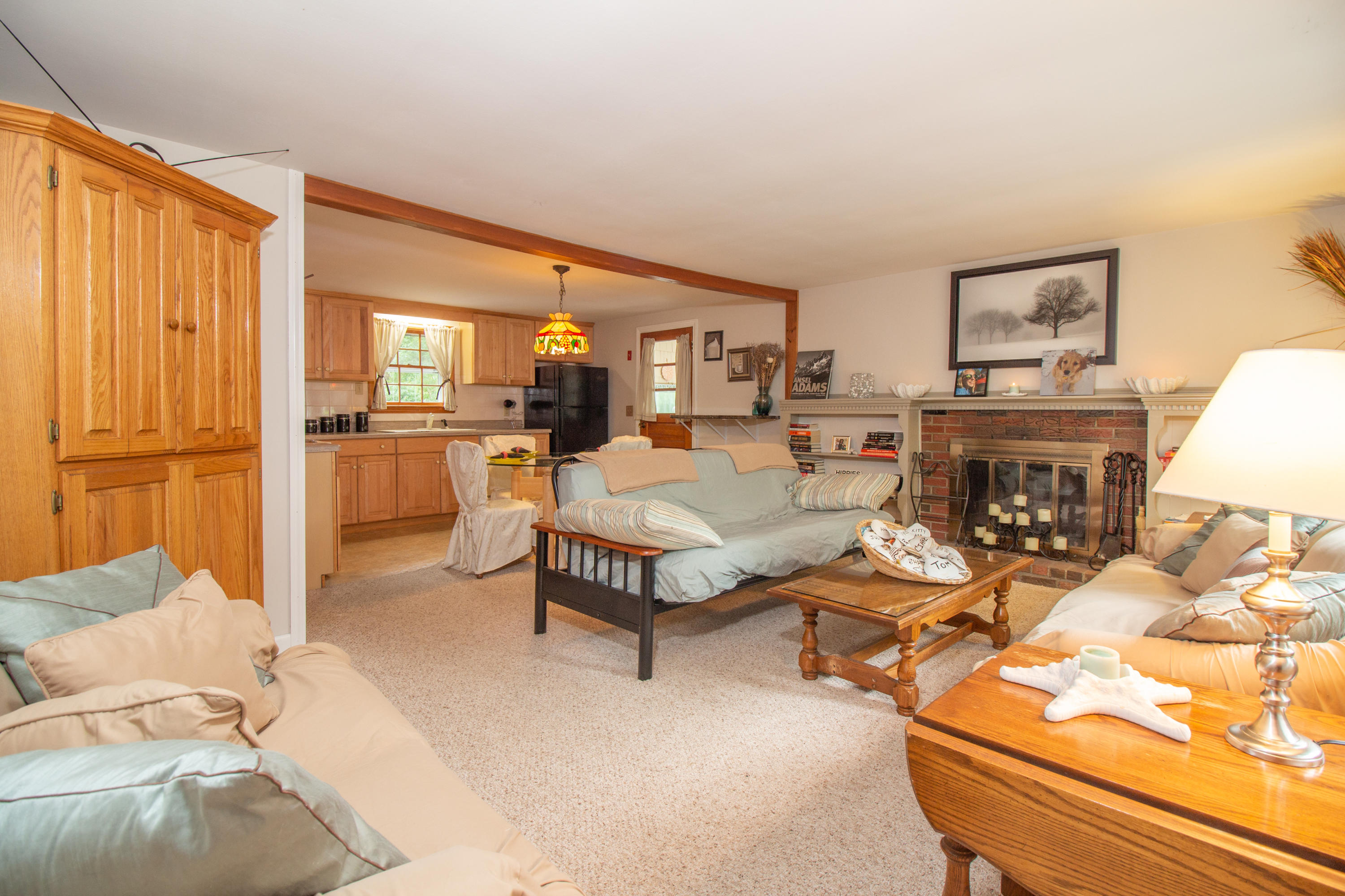 52 Farm Hill Road Centerville, MA 02632 - Photo 5 of 29 a living room with furniture a fireplace and a table