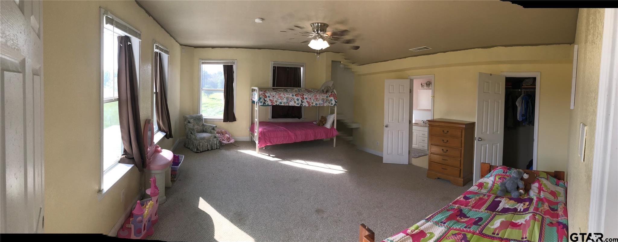 1100 East Rabbit Cove Road Quinlan, TX 75474 - Photo 11 of 18 a bedroom with furniture and a baby crib