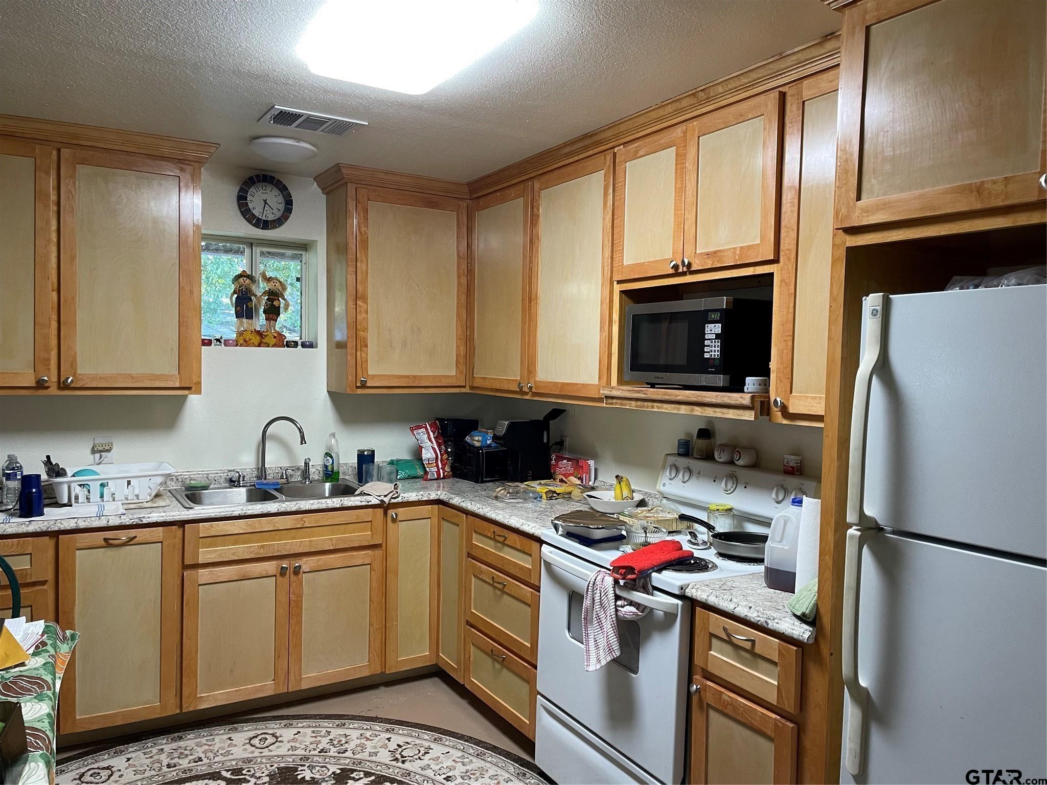1100 East Rabbit Cove Road Quinlan, TX 75474 - Photo 17 of 18 a kitchen with a sink stove and refrigerator