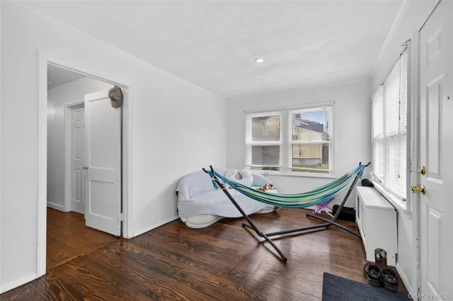 a living room with furniture a wooden floor and a window