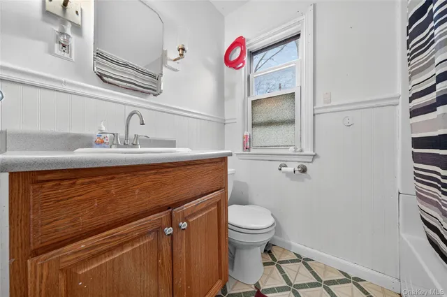 a bathroom with a sink a toilet and mirror