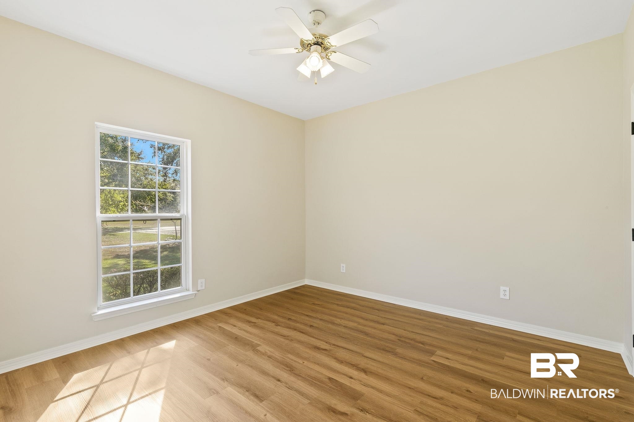 9631 Bay Meadows Avenue Fairhope, AL 36532 - Photo 27 of 49 Unfurnished bedroom with ceiling fan and hardwood / wood-style flooring.
