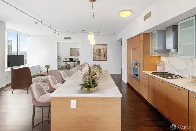 a living room with kitchen island furniture and a table