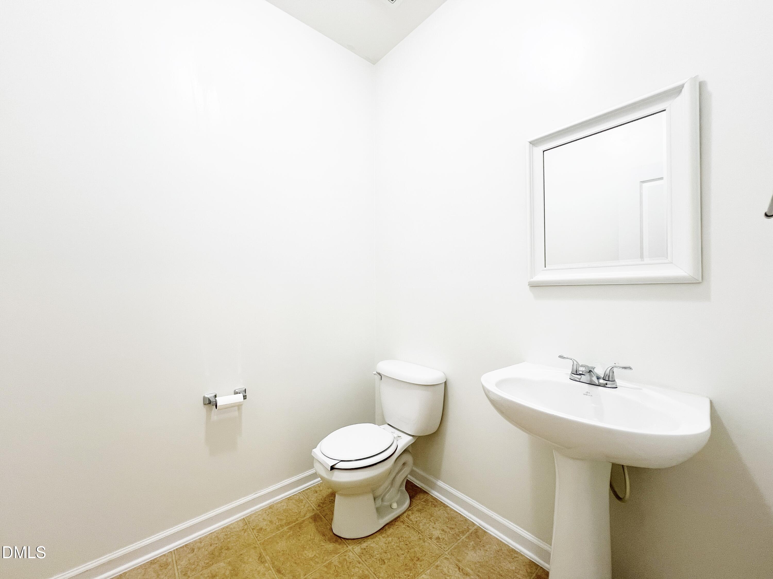 1495 Willowcrest Road Durham, NC 27703 - Photo 13 of 35 a white toilet sitting next to a bathroom sink