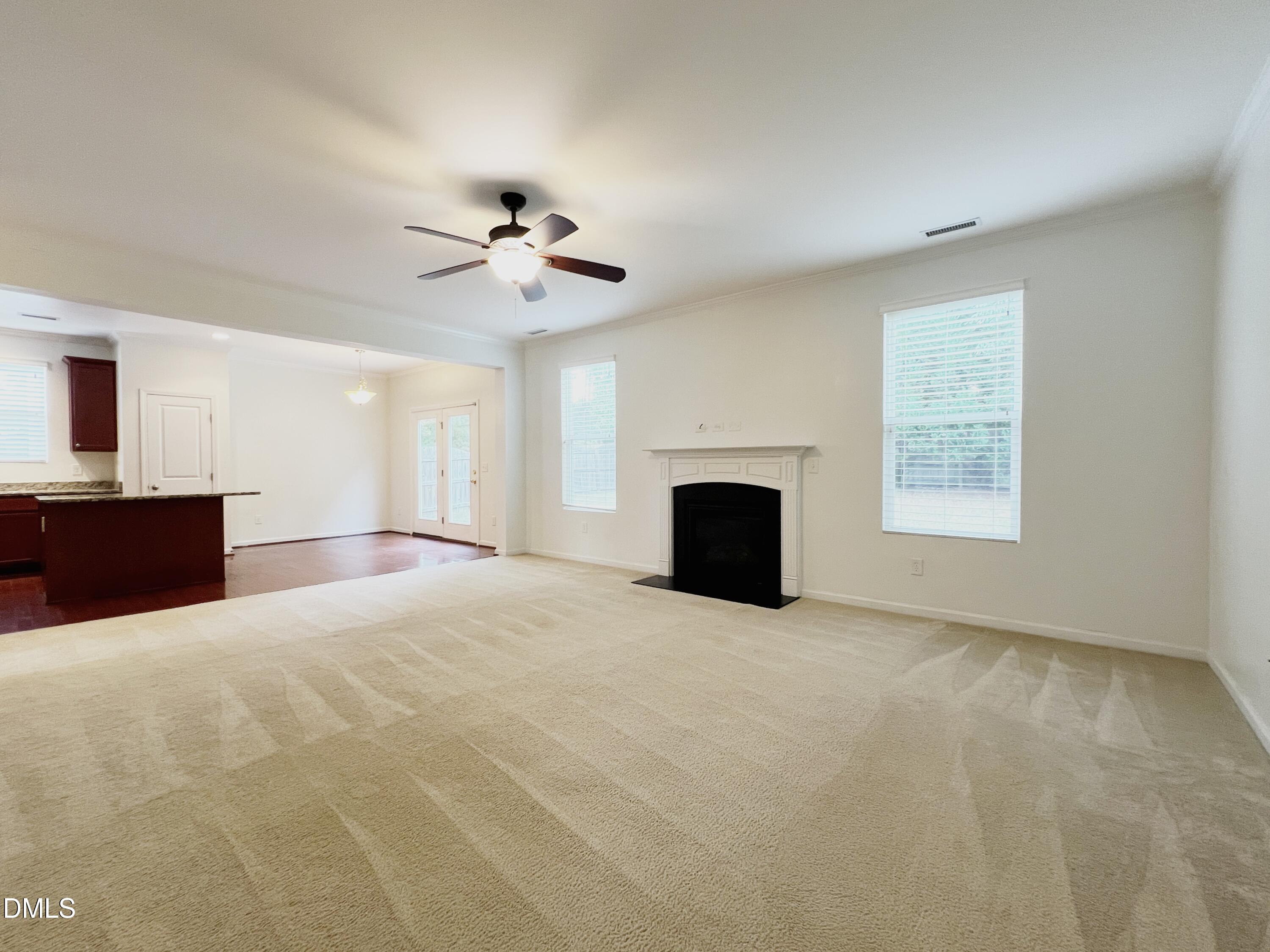 1495 Willowcrest Road Durham, NC 27703 - Photo 15 of 35 a view of an empty room with a fireplace and a window
