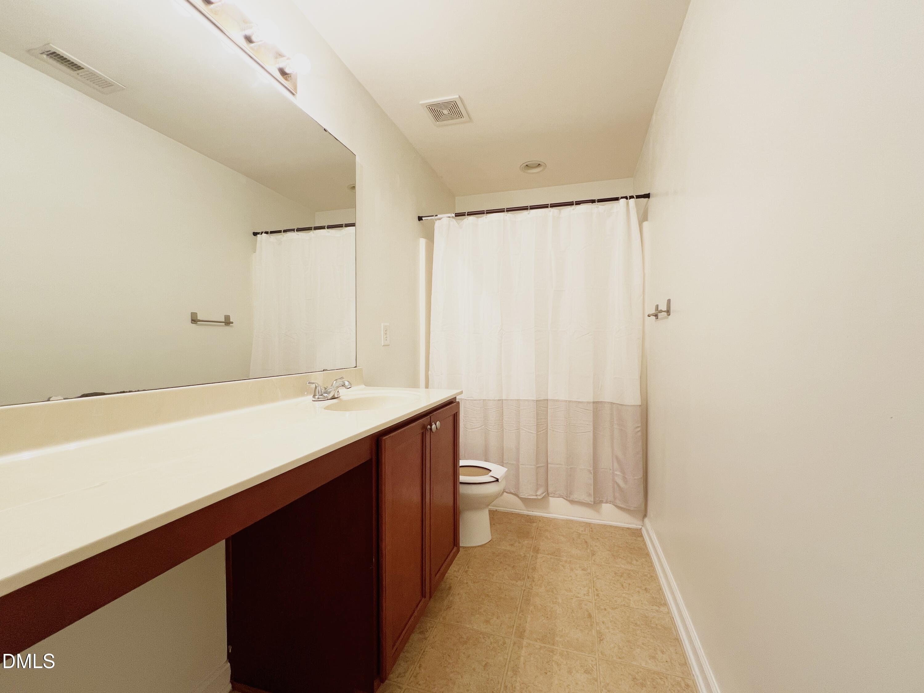 1495 Willowcrest Road Durham, NC 27703 - Photo 26 of 35 a bathroom with a sink a toilet and shower