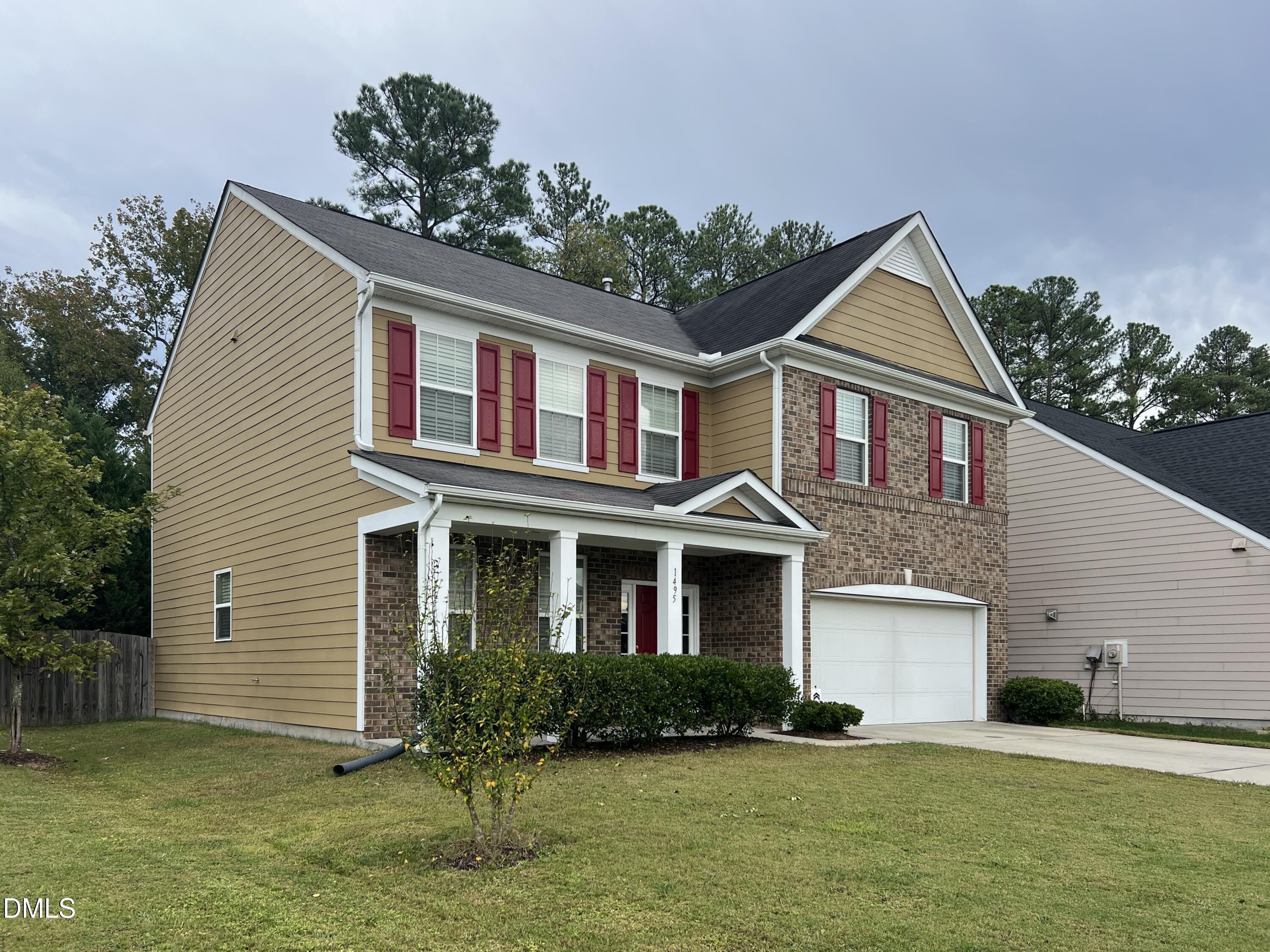 1495 Willowcrest Road Durham, NC 27703 - Photo 3 of 35 a front view of a house with a yard and garage