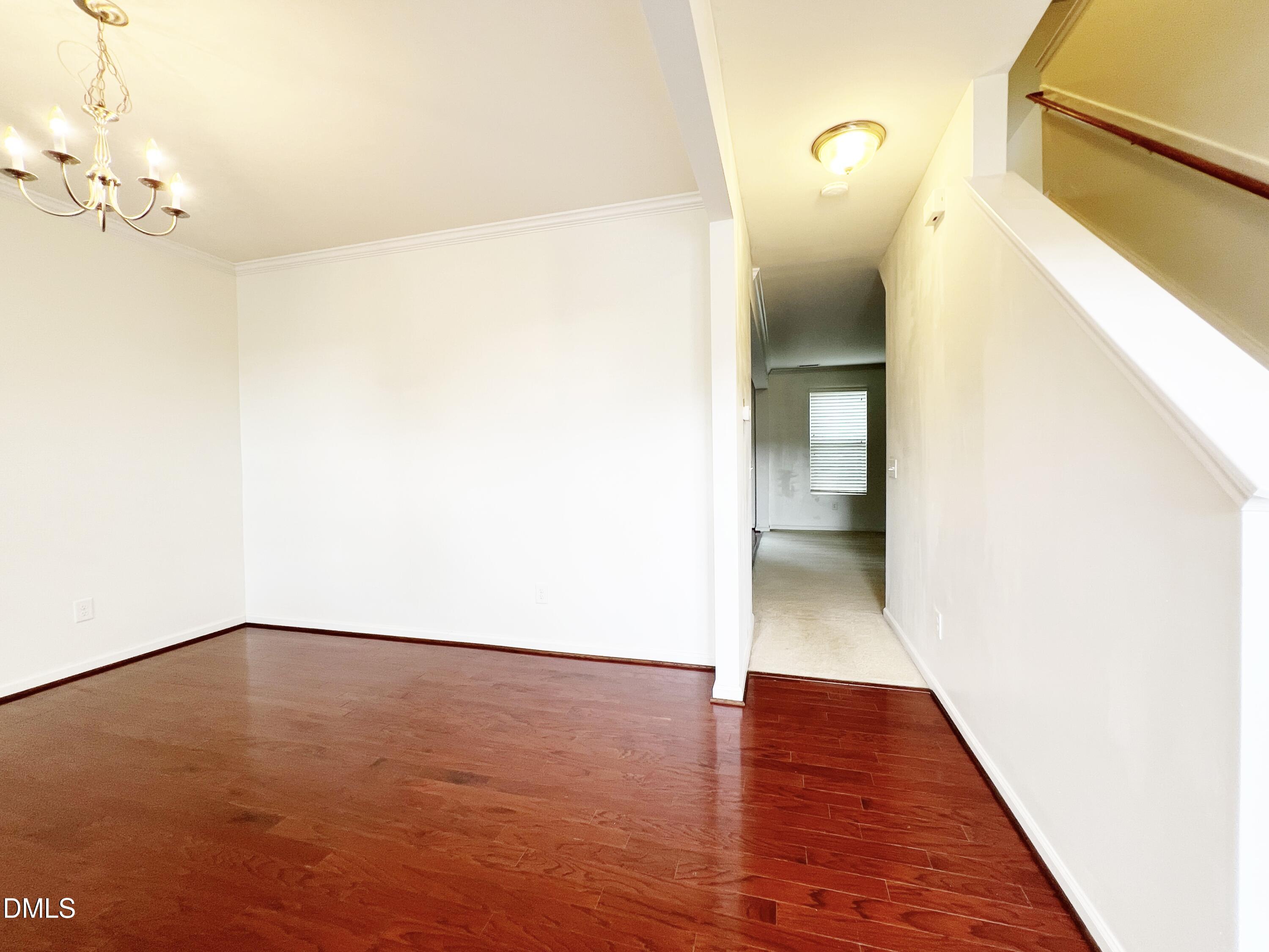 1495 Willowcrest Road Durham, NC 27703 - Photo 5 of 35 a view of an empty room with wooden floor