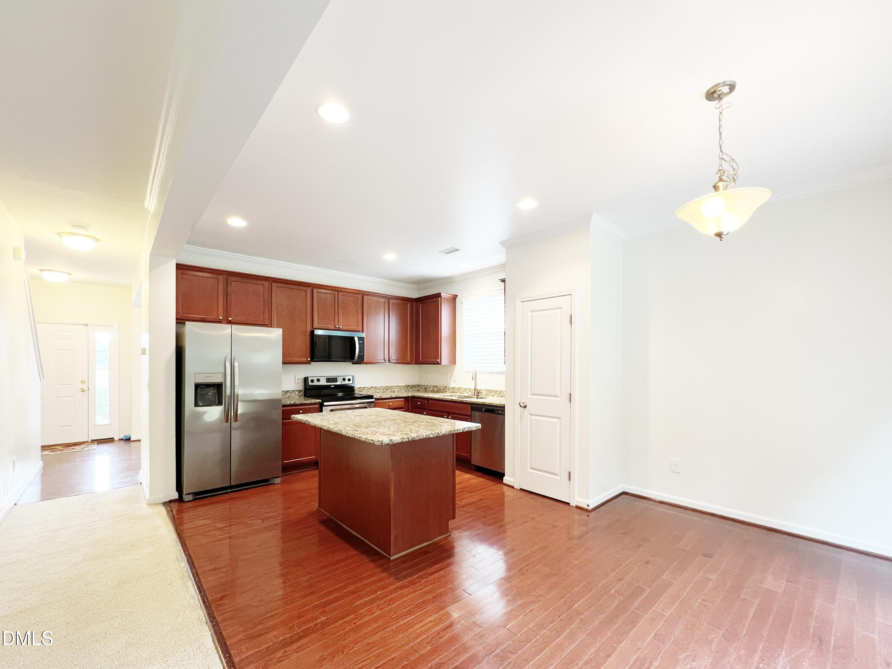 1495 Willowcrest Road Durham, NC 27703 - Photo 8 of 35 a kitchen with stainless steel appliances granite countertop a refrigerator a sink dishwasher a stove and white cabinets with wooden floor