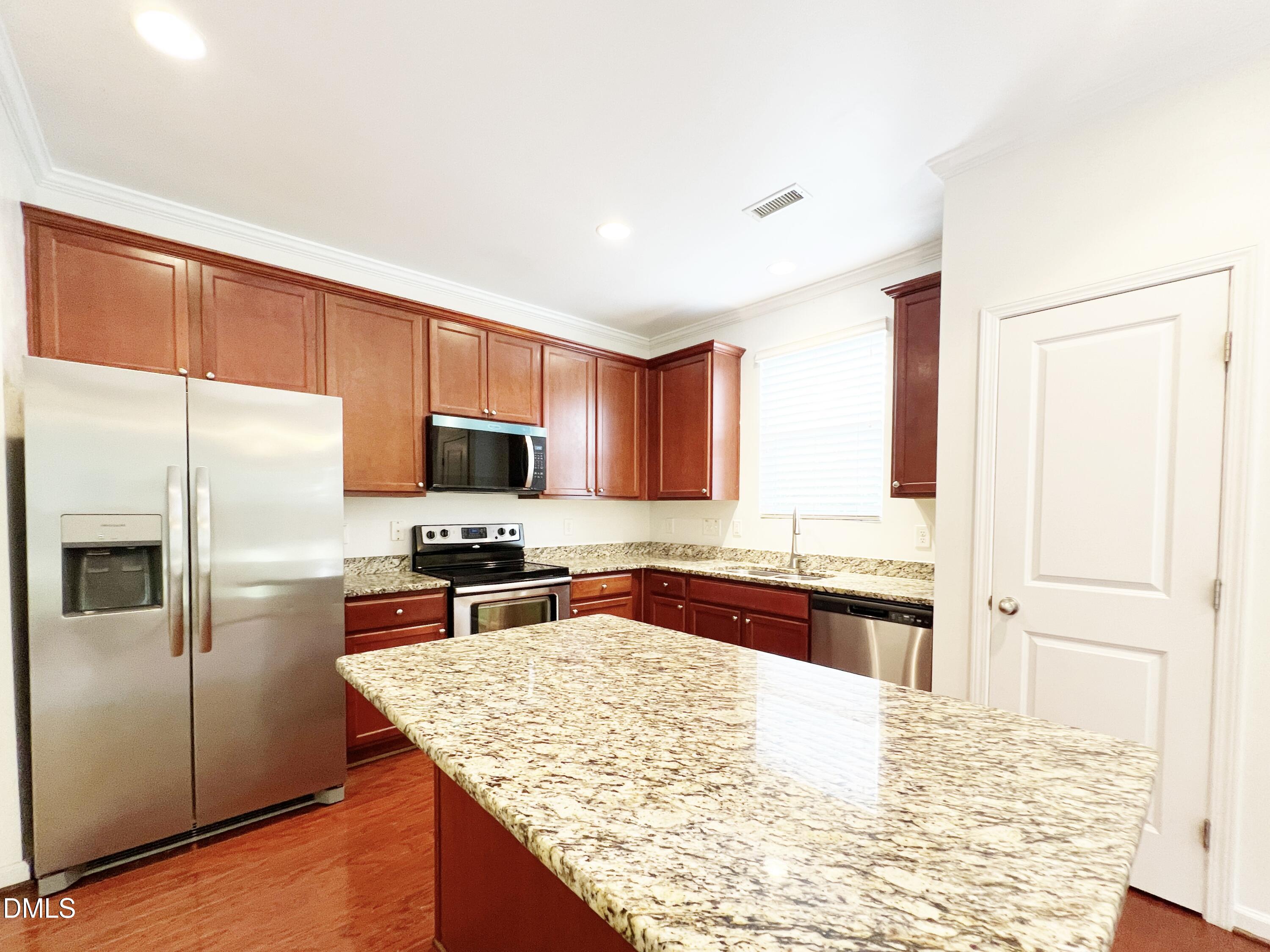 1495 Willowcrest Road Durham, NC 27703 - Photo 9 of 35 a kitchen with granite countertop a refrigerator stove and sink