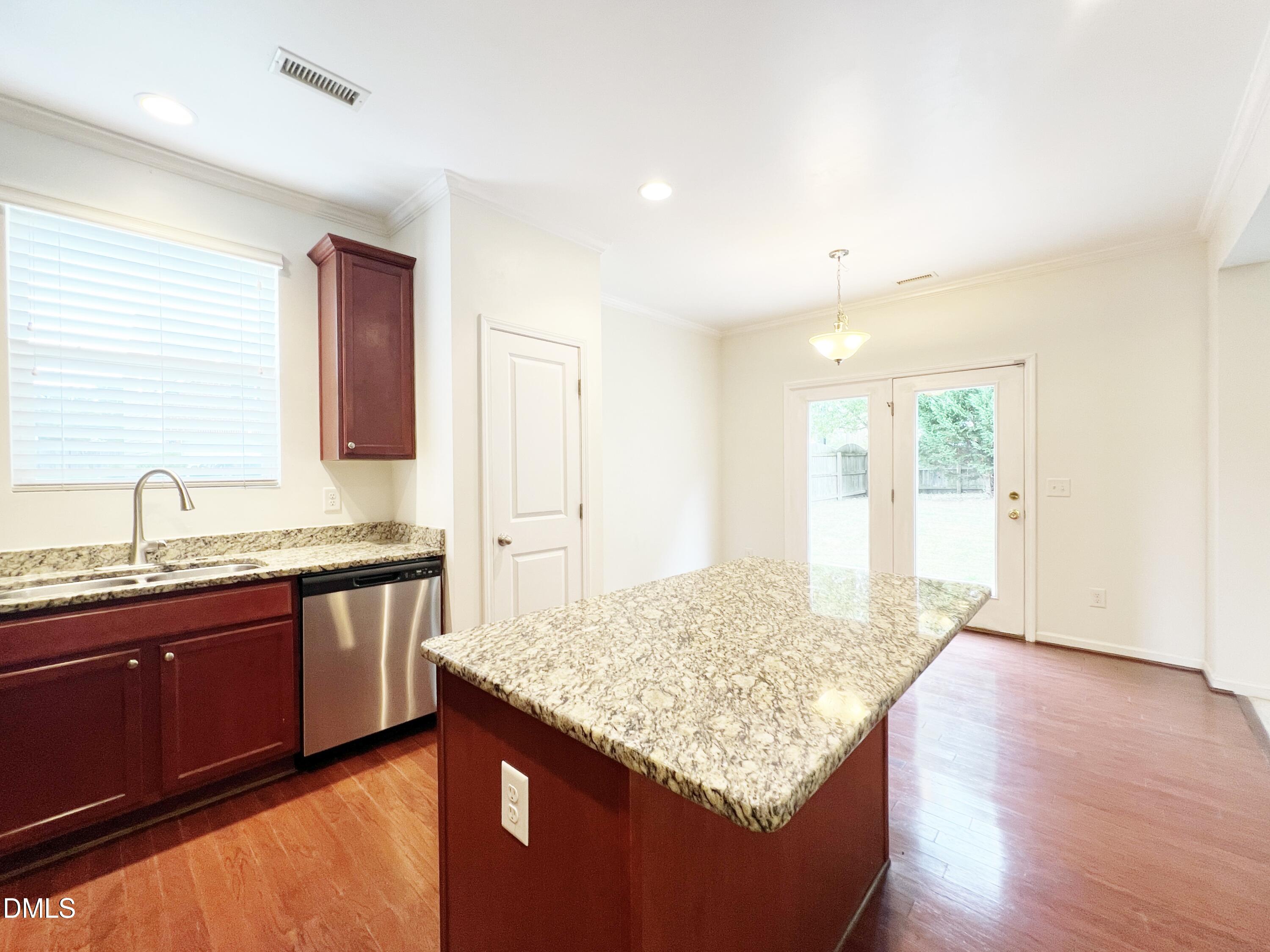 1495 Willowcrest Road Durham, NC 27703 - Photo 10 of 35 a kitchen with granite countertop sink and cabinets
