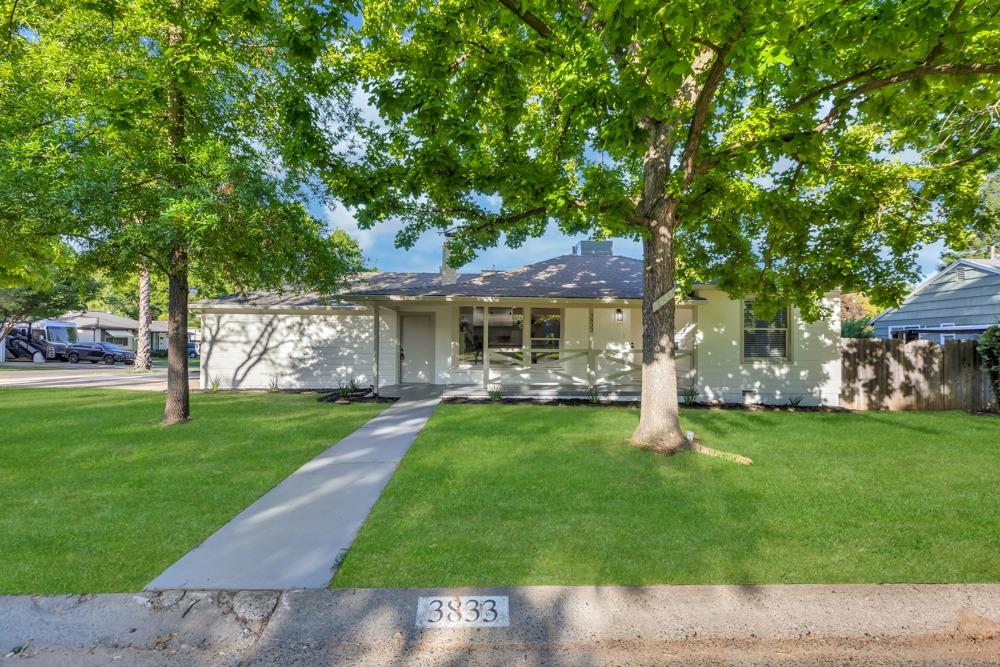 a front view of a house with a garden
