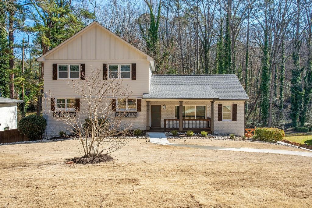 a front view of a house with a yard covered in snow