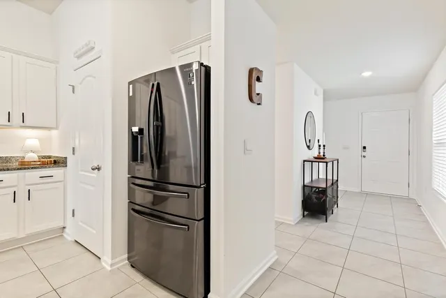 a kitchen with appliances cabinets and furniture