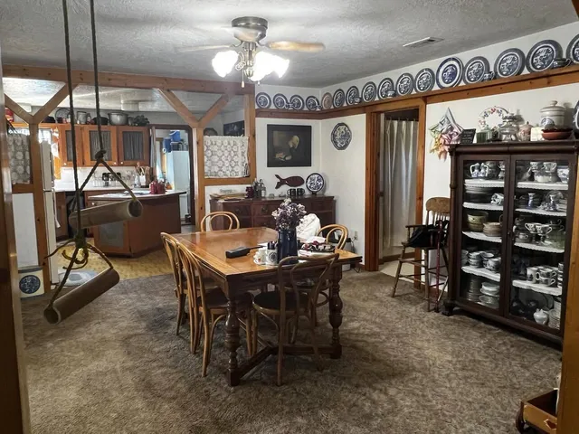 a view of a chair and table in the backyard