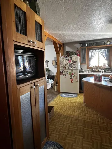 a kitchen with a refrigerator and a stove top oven