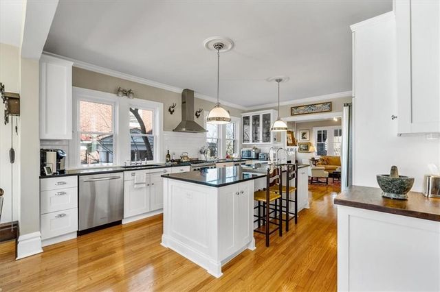 a kitchen with stainless steel appliances granite countertop a stove and a sink