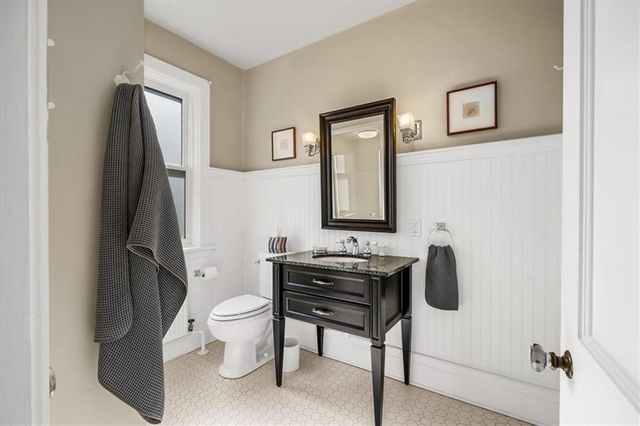 a bathroom with a toilet a sink and a mirror