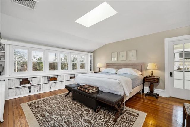 a bed room with a bed and a chair