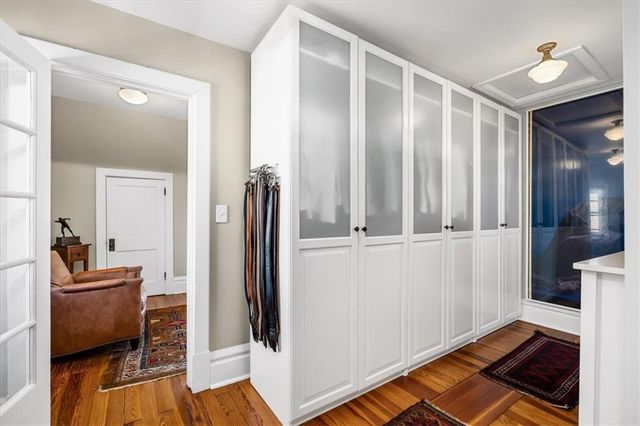 a view of a livingroom with wooden floor and furniture