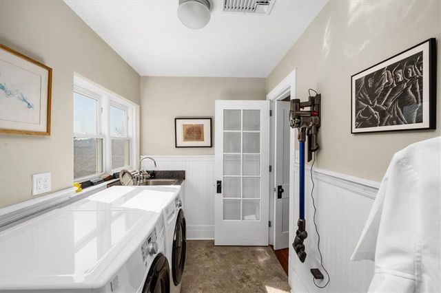 a bathroom with double vanity sink and a mirror