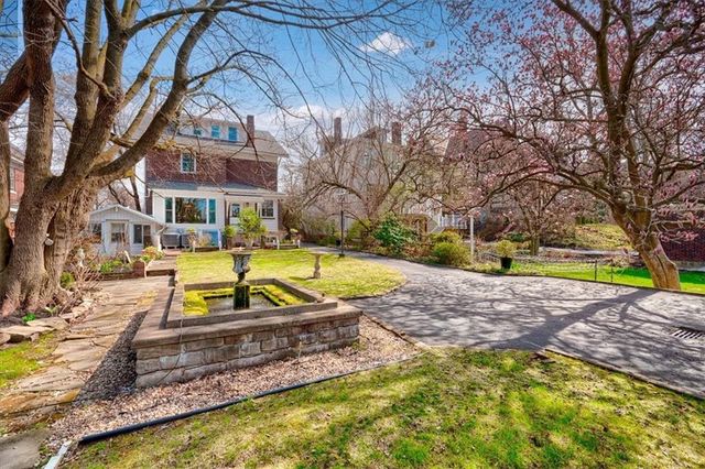 a view of swimming pool with lawn chairs under an umbrella