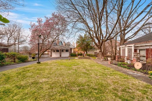 a view of a yard with a house in the background