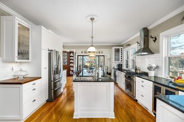 a kitchen with refrigerator a stove and a sink