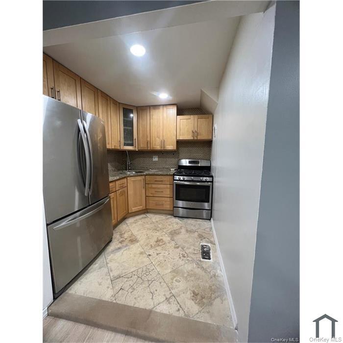 803 Jackson Avenue, Unit A Bronx, NY 10456 - Photo 3 of 8 a kitchen with stainless steel appliances a refrigerator and a stove