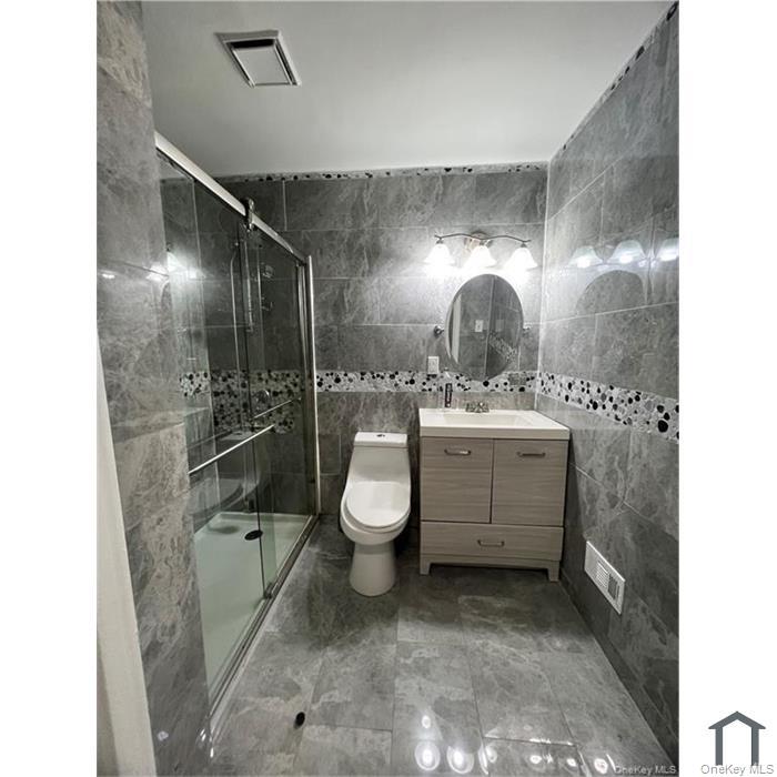 803 Jackson Avenue, Unit A Bronx, NY 10456 - Photo 5 of 8 a bathroom with a sink toilet and shower